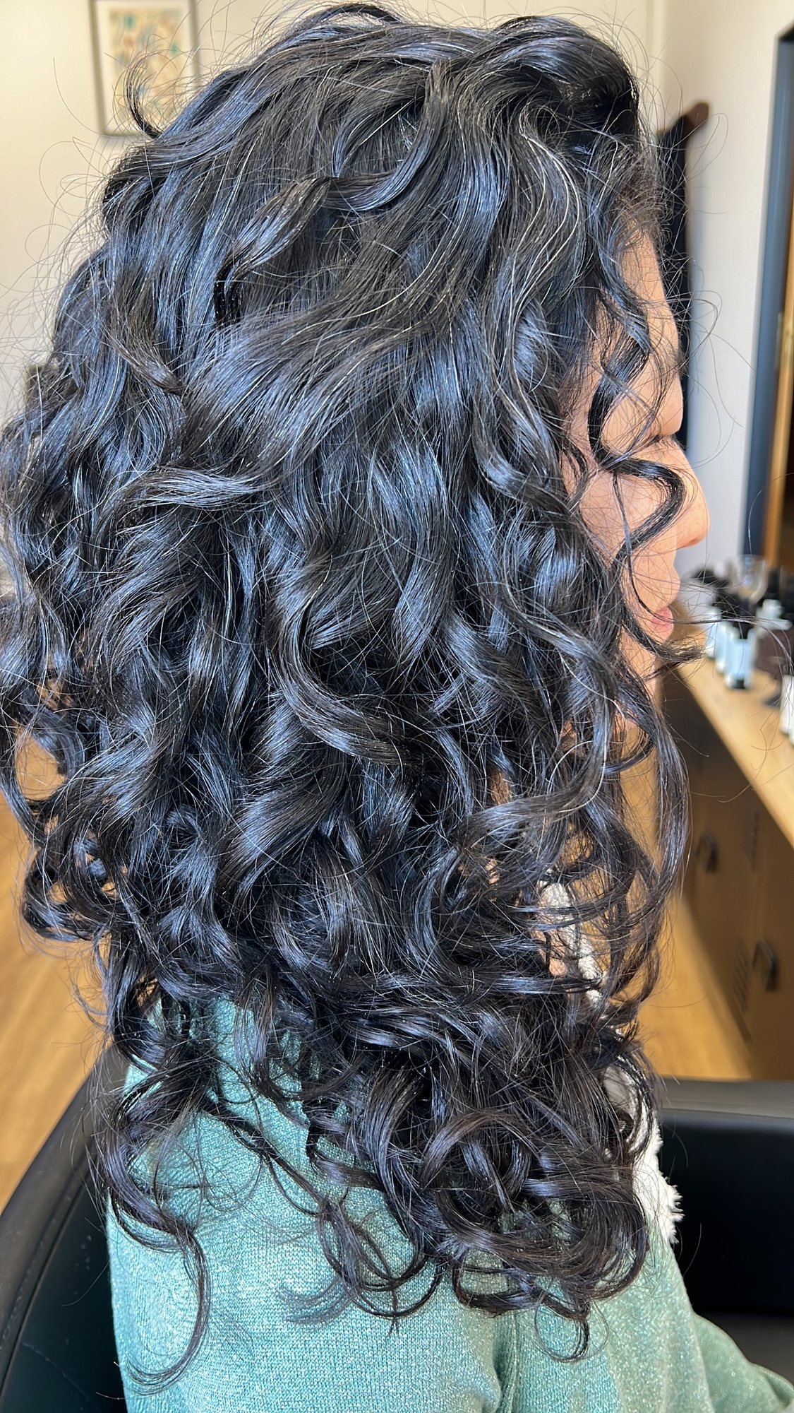 Long, defined dark curls after a curly cut