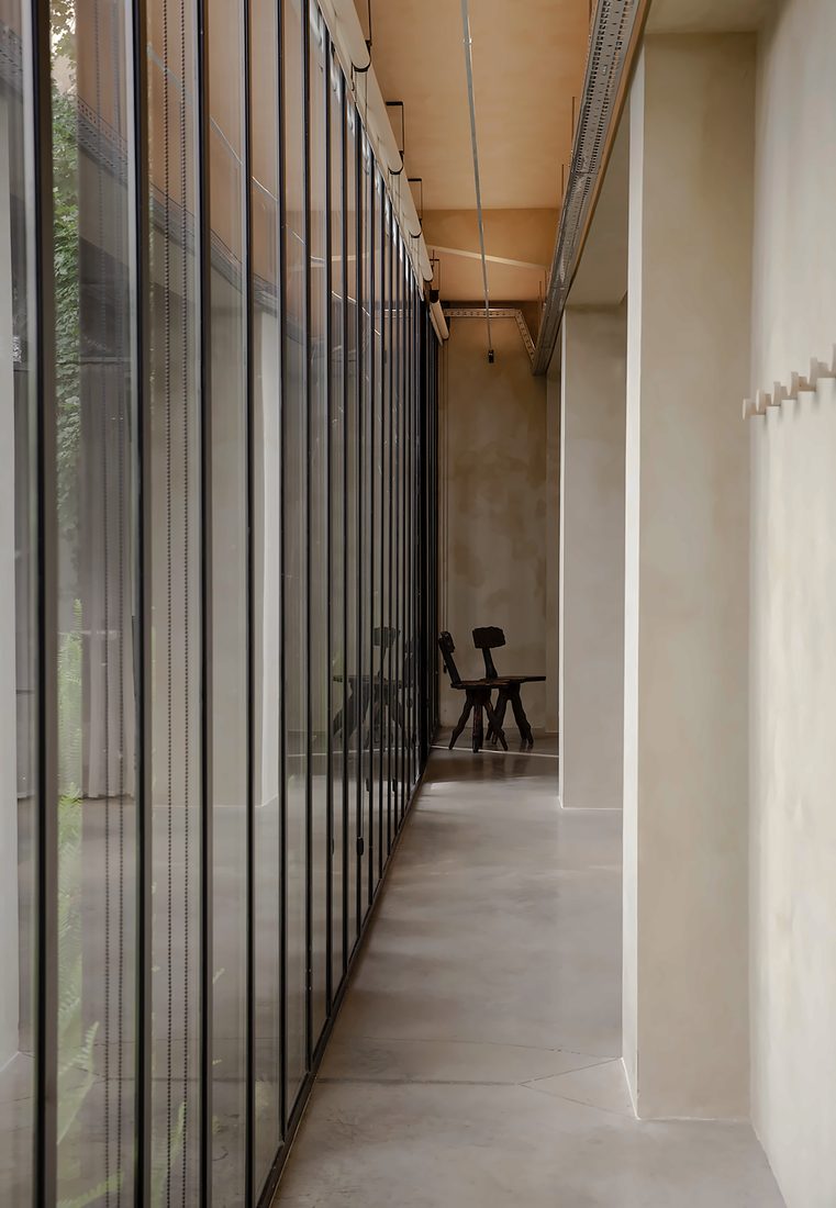 A quiet corridor with a long glass wall onto the garden